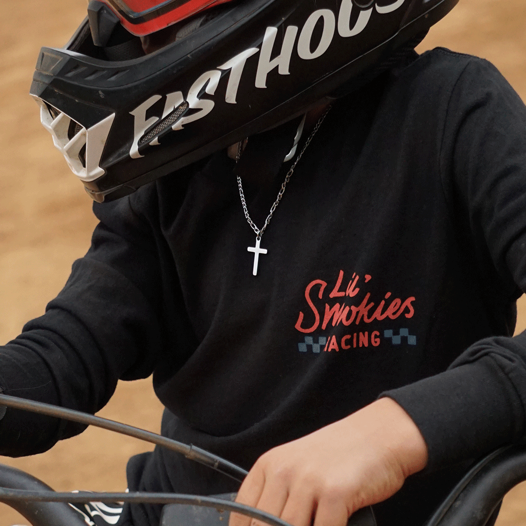 Youth motocross rider. Wearing dirtbike gear. MX gear featuring moto apparel design.