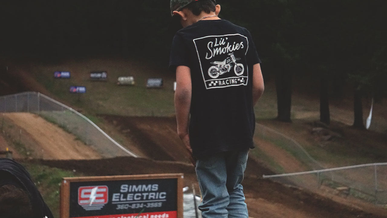 Photo: a day and the the track is a day well spent. Youth motocross racer studying the racetrack wearing Lil' Smokies Racing gear.