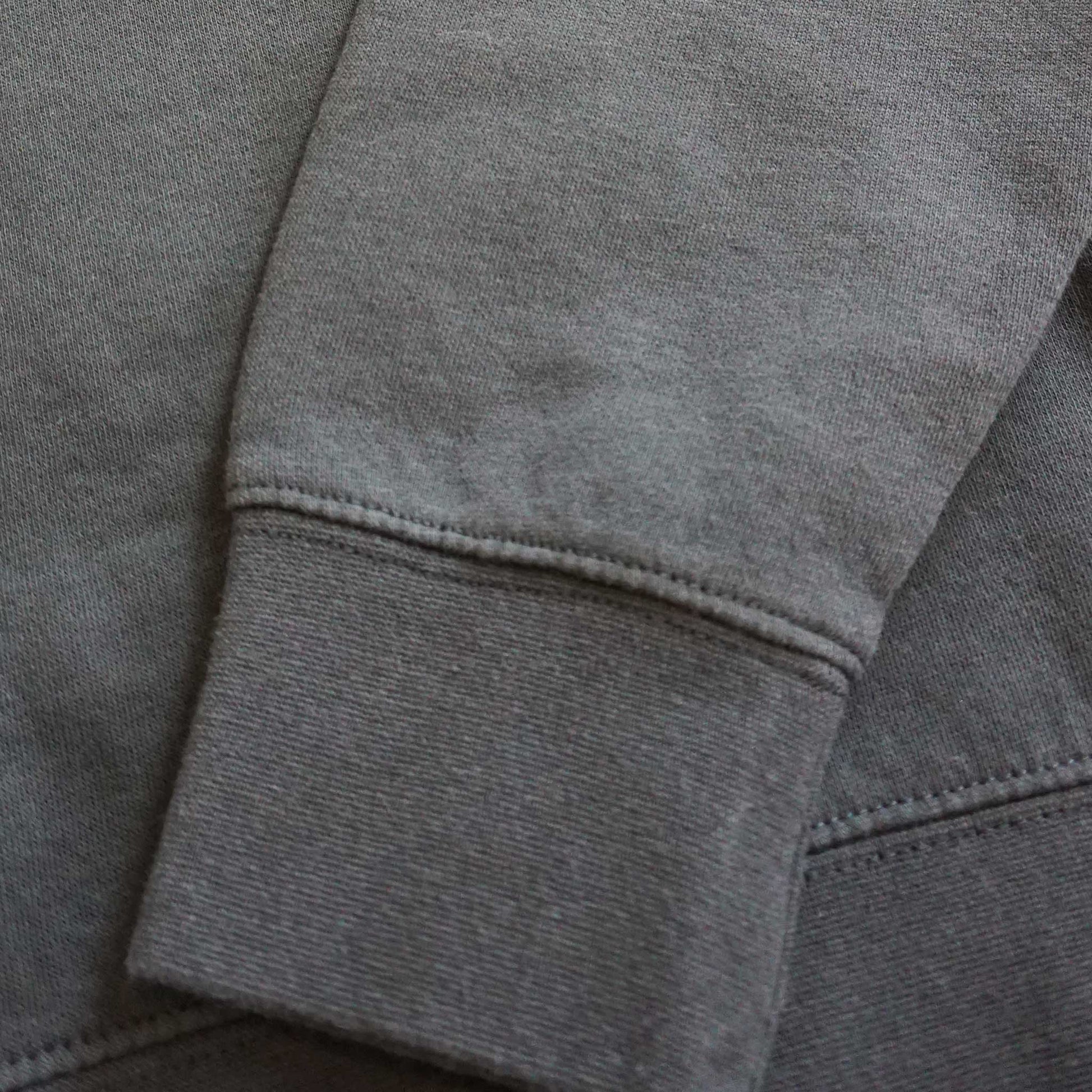 Clost up image of the sleeve detail in the crew neck sweatshirt. Tighter cuff on the sweatshirt for a quality product.