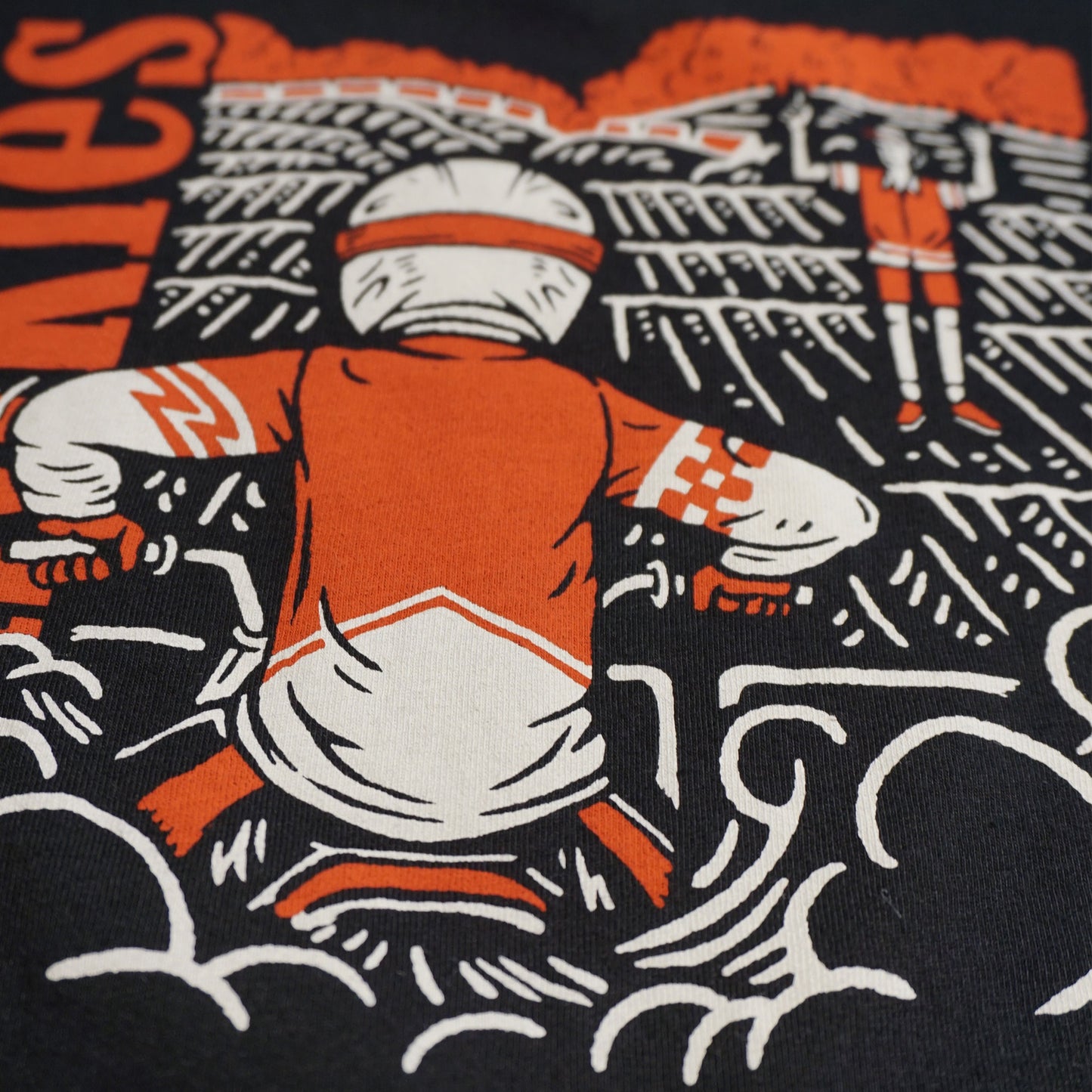 Close up image of the back of the tshirt. Focused on the dirt bike rider at the starting gate elbows up, waiting for the starter to drop the gate Image is in white and red water based ink.