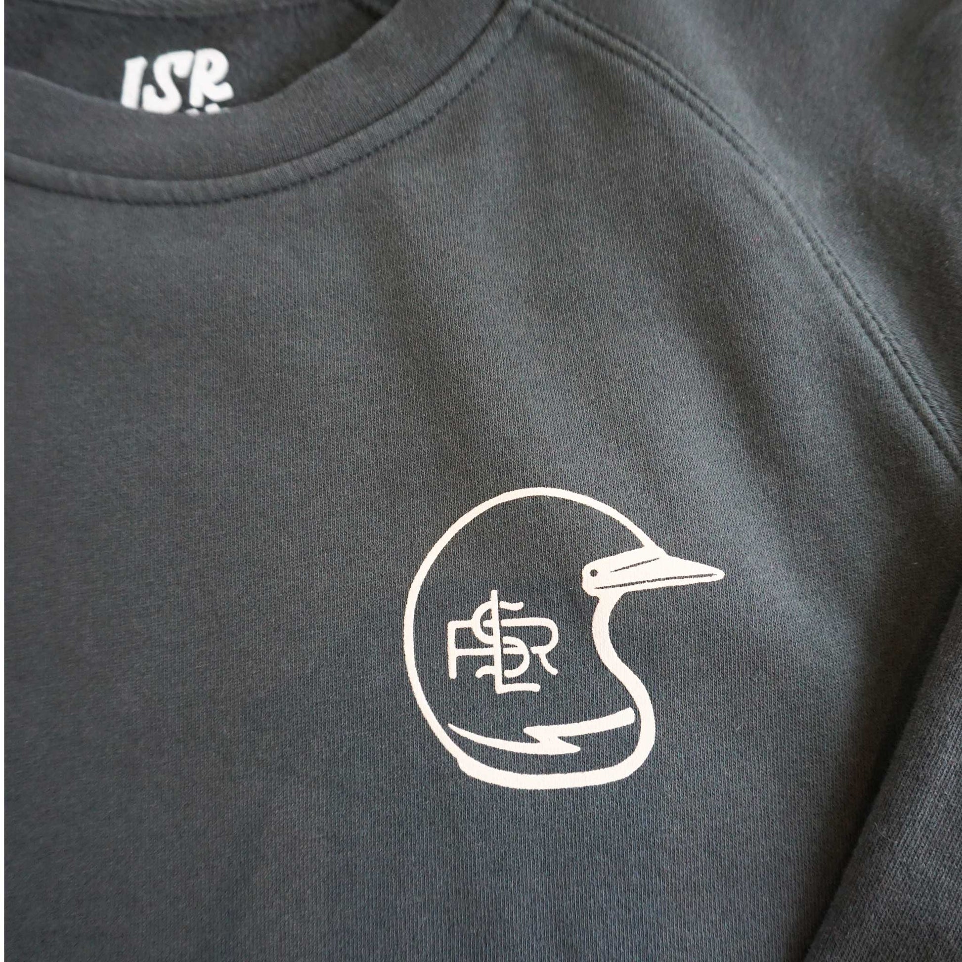 Close up image of the left front chest of the sweatshirt. Detalis of the interior branding as well as raglan sleeve stitching. Vintage motocross helmet with Lil Smokies Racing logo and lightening bolt.