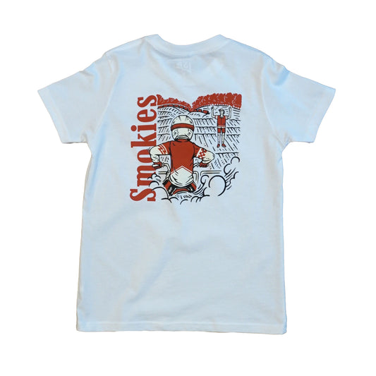 Back image of the Smokies white tshirt in youth sizing. Full graphic on the back with the word Smokies written vertical on the left in red with a dirt bike rider elbows up at the starting gate waiting for the starter to come back and drop the gate.