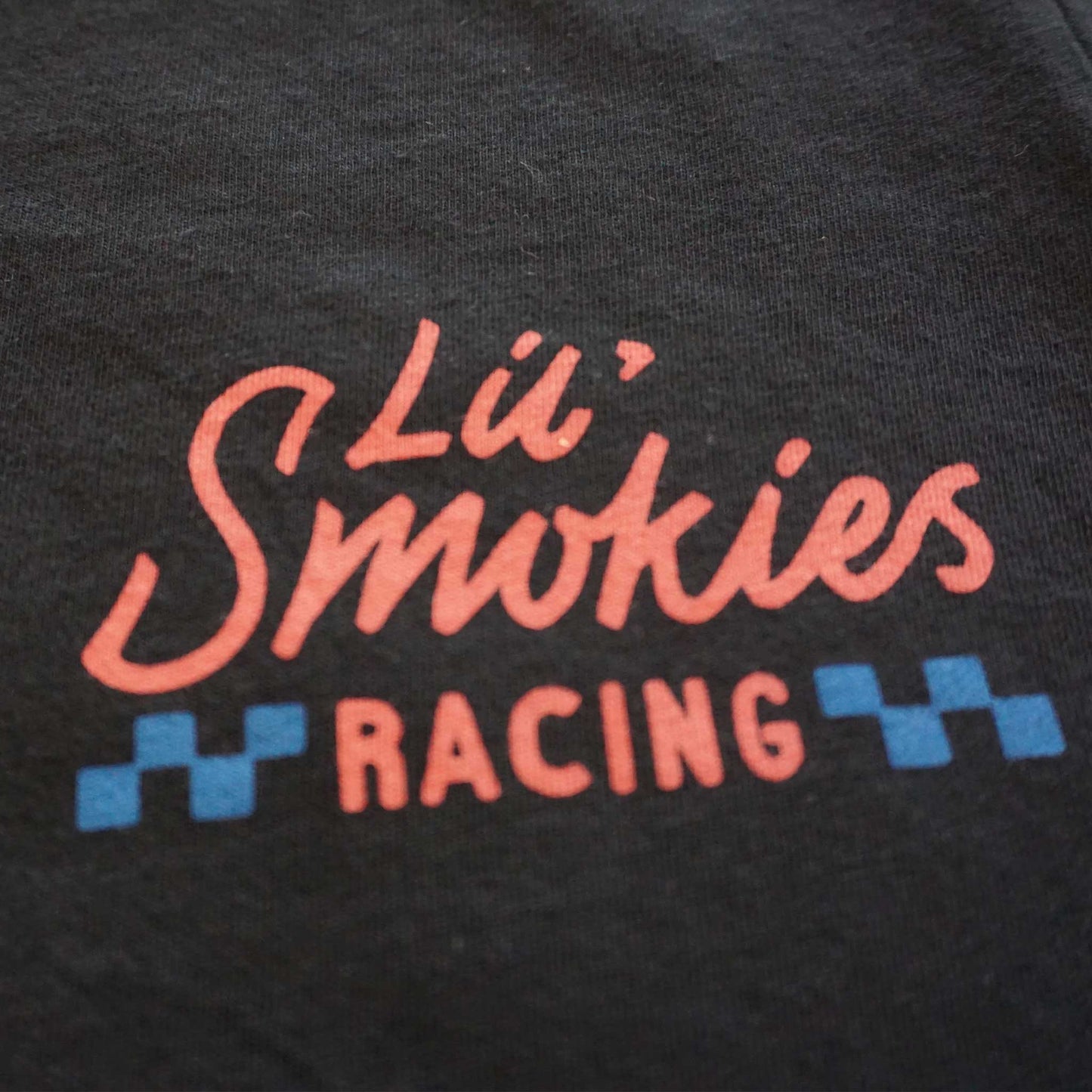 Close up image of the left front chest with the Lil Smokies Racing logo in a soft red and blue colorway.