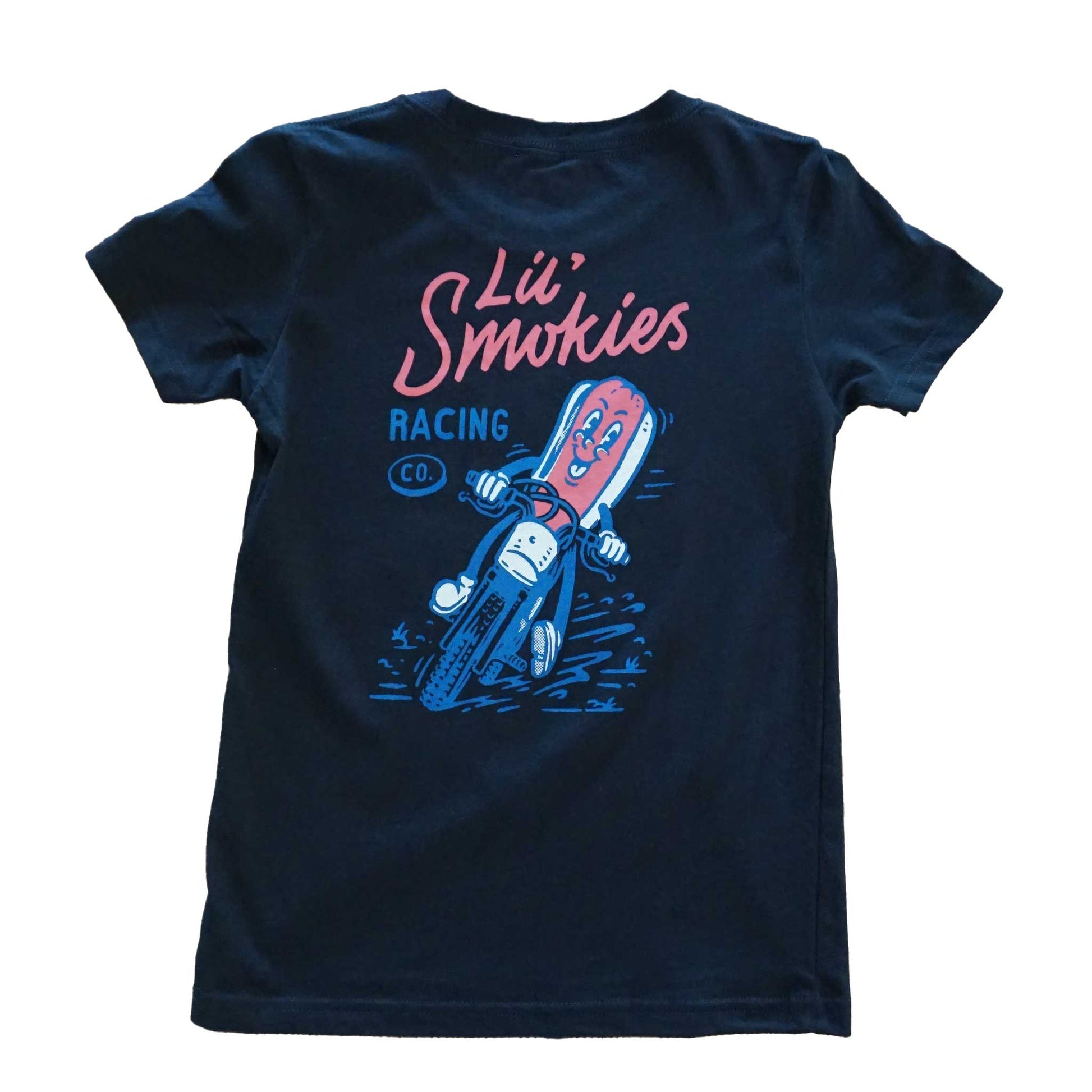 Youth black short sleeve tshirt with Lil' Smokies racing font logo. A hotdog in a bun riding a motorcycle with a big smile on its face and dirt flying up from the tires. Playful cartoon image of what we call a burnt dog.